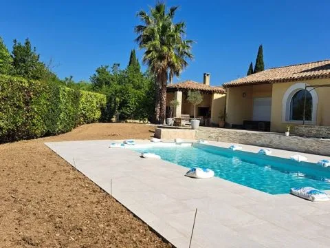 Pose de plaques de pelouse : gazon en plaques posé autour d'une piscine, dalles claires en bordure, photo 3