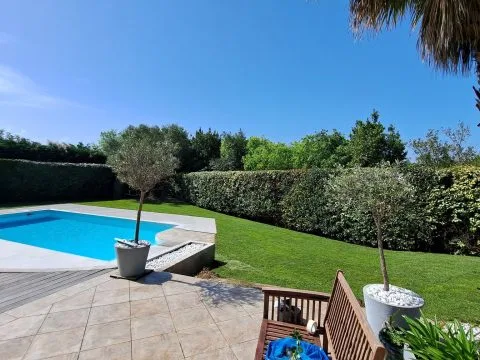 Pose de plaques de pelouse : gazon en plaques posé autour d'une piscine, dalles claires en bordure, photo 4