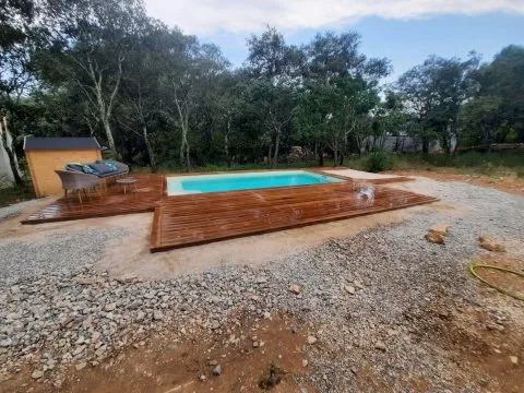 Terrasse pour piscine : platelage en bois exotique autour d'un bassin, en cours de pose, photo 2